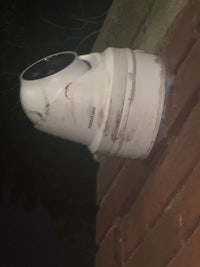 cctv camera on a brick wall at night